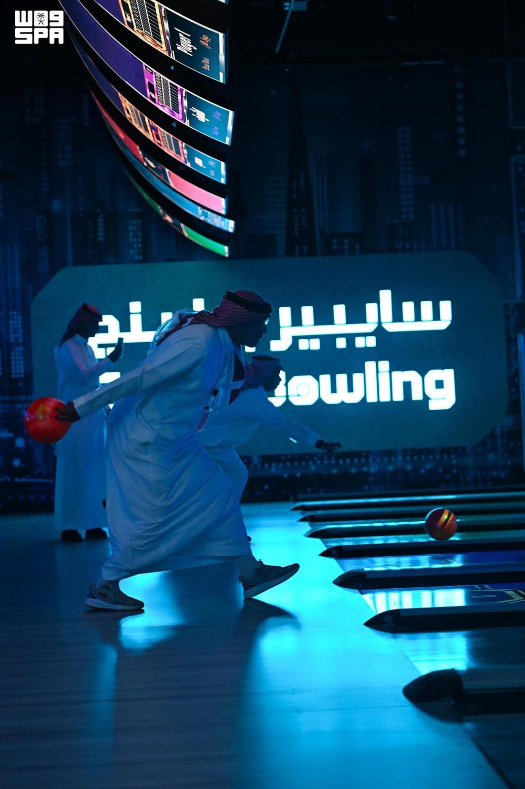 A guest bowling beneath the Cyber Bowling sign
